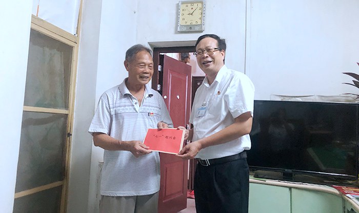 校长黄杰品为老党员钟乃德同志送上慰问金.jpg